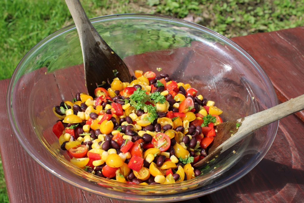 glass bowl with tomato sweetcorn bean salad