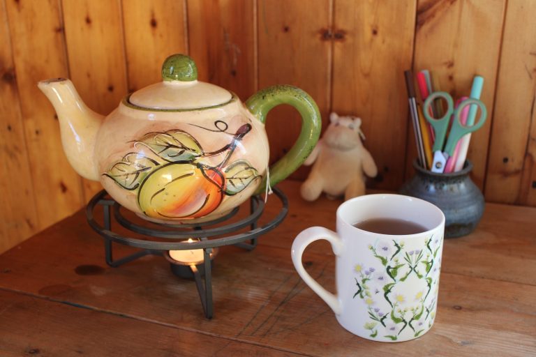 teapot with cup on a desk