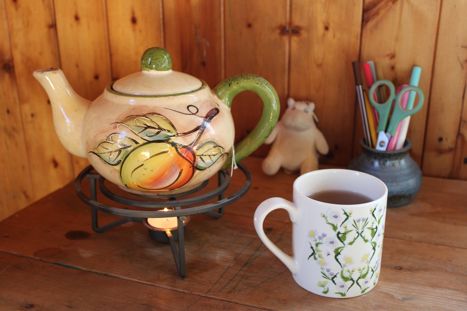 teapot with cup on a desk