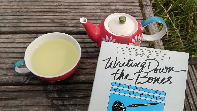 pot of herbal tea and book