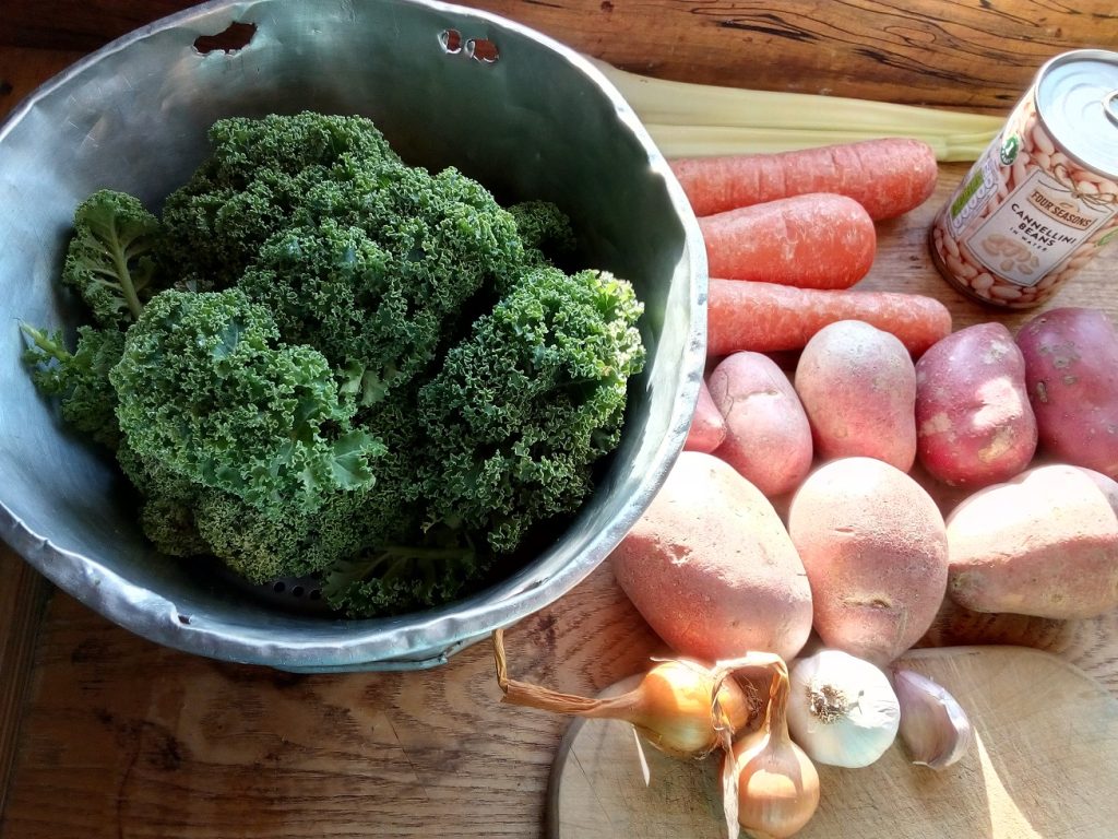 curly kale, potatoes, carrots ready to be chopped