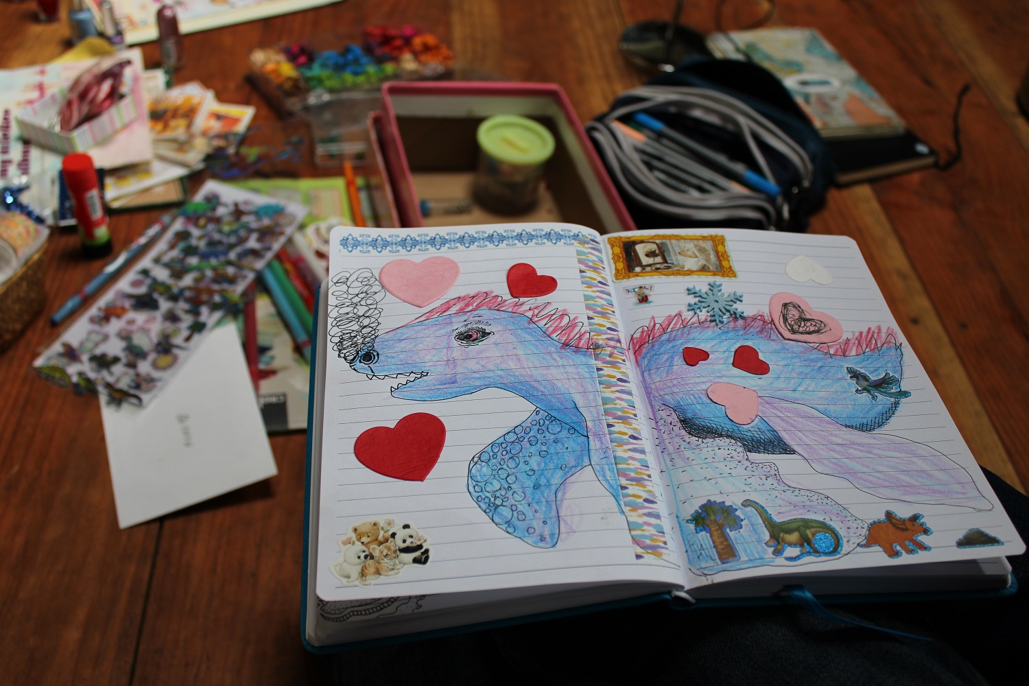 open sketchbook with blue dinosaur