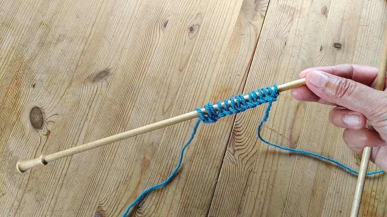 wooden knitting needle with cast on stitches